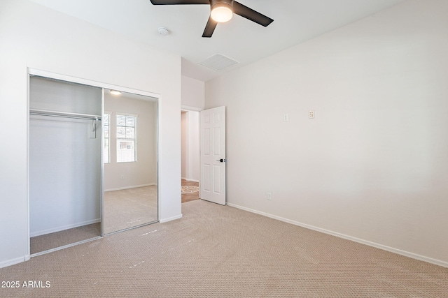 unfurnished bedroom featuring a closet, light colored carpet, visible vents, a ceiling fan, and baseboards