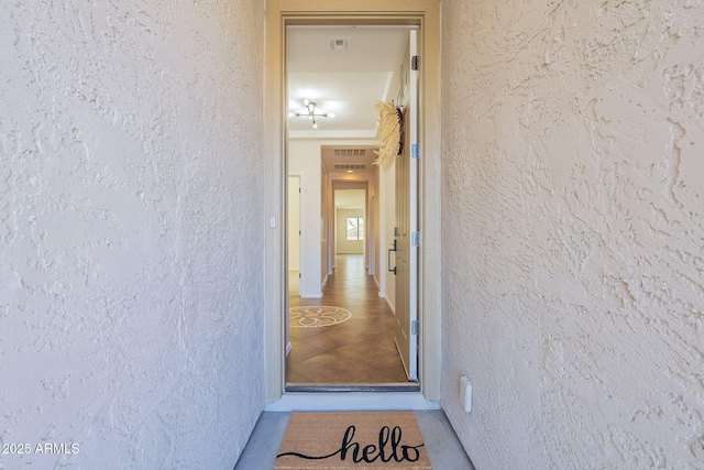 doorway to property with visible vents and stucco siding