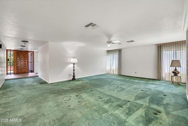 7037 N 11th Dr, Phoenix, AZ 85021 - carpeted spare room with ceiling fan, baseboards, and a textured ceiling