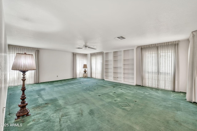 7037 N 11th Dr, Phoenix, AZ 85021 - unfurnished living room with carpet, ceiling fan, and built in features