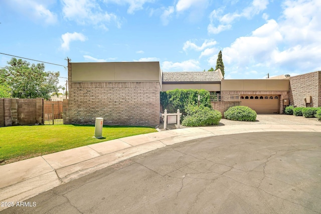 7037 N 11th Dr, Phoenix, AZ 85021 - view of front of property with a garage, driveway, stucco siding, and brick siding