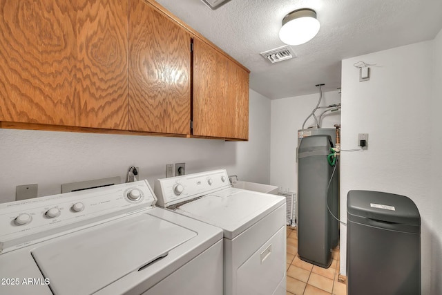 7037 N 11th Dr, Phoenix, AZ 85021 - laundry area with cabinet space, separate washer and dryer, a textured ceiling, and light tile patterned floors