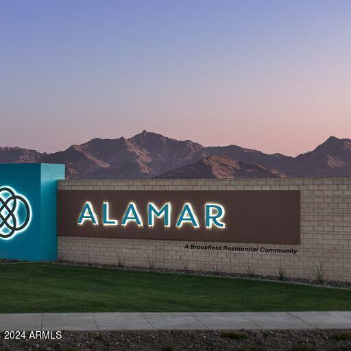 community sign with a yard and a mountain view