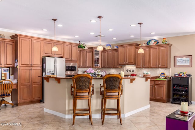 kitchen with pendant lighting, backsplash, stainless steel appliances, an island with sink, and a kitchen bar