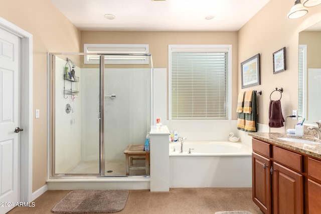 bathroom featuring plus walk in shower and vanity