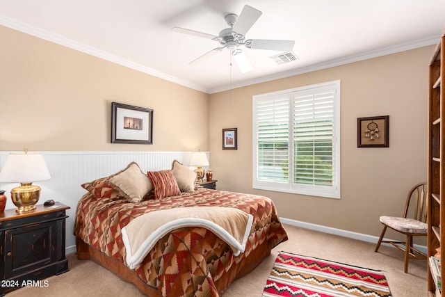 carpeted bedroom featuring crown molding and ceiling fan