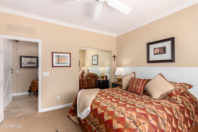 carpeted bedroom with crown molding and ceiling fan