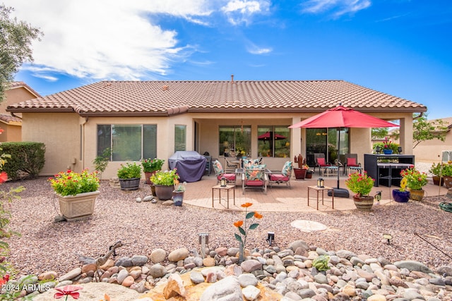 back of property with a patio