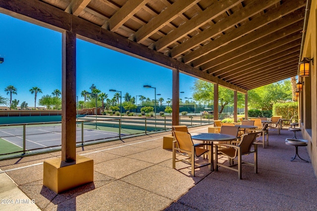 view of patio / terrace with tennis court