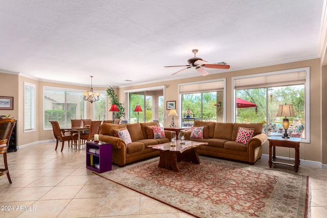 living room featuring ceiling fan with notable chandelier, ornamental molding, a textured ceiling, and light tile patterned flooring