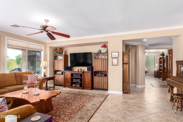 tiled living room with ornamental molding and ceiling fan