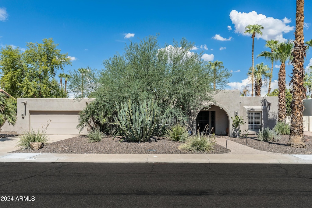 pueblo-style home with a garage