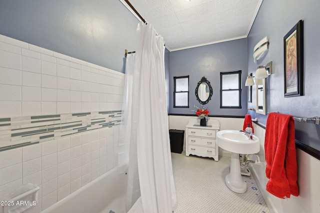 bathroom with crown molding and shower / tub combo with curtain
