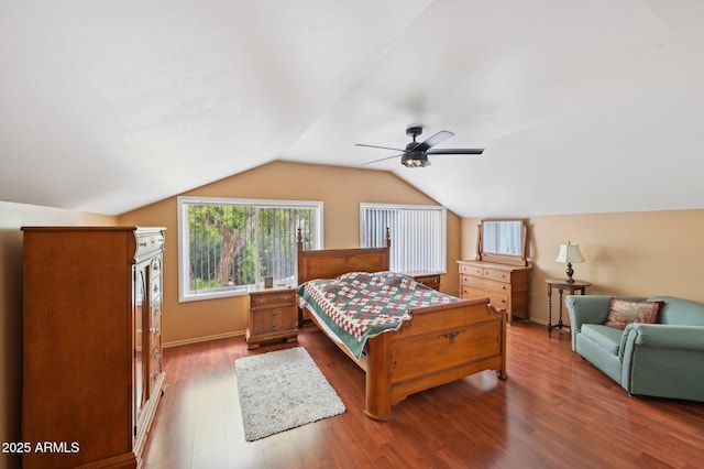 bedroom featuring baseboards, a ceiling fan, wood finished floors, and vaulted ceiling