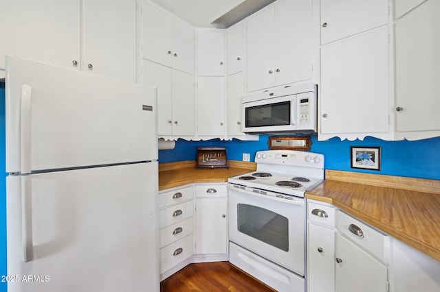 kitchen featuring light countertops, white cabinets, white appliances, and dark wood-style floors