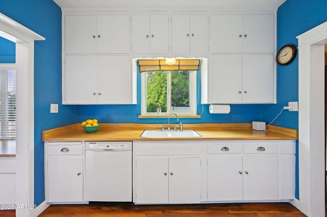 kitchen with a sink, light countertops, white cabinets, and dishwasher
