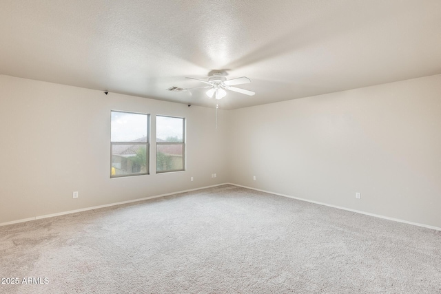 empty room featuring a ceiling fan, baseboards, carpet, visible vents, and a textured ceiling