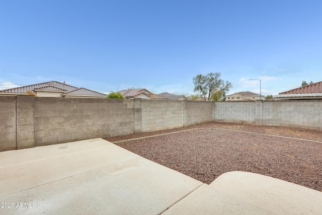 view of yard featuring a patio and a fenced backyard