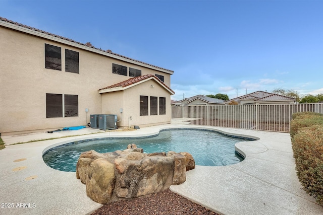 view of swimming pool with a patio, a fenced backyard, a fenced in pool, and central AC