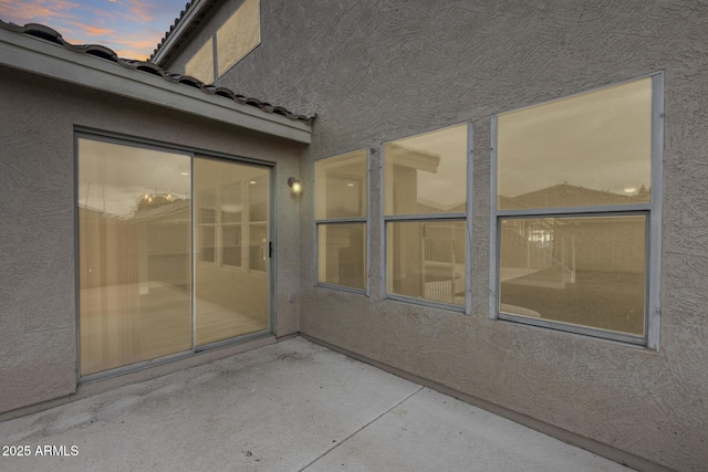 view of patio terrace at dusk