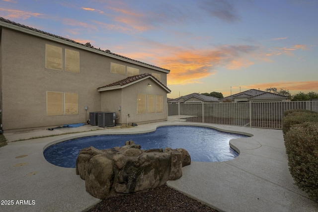 view of pool featuring a patio area, a fenced in pool, central AC, and a fenced backyard