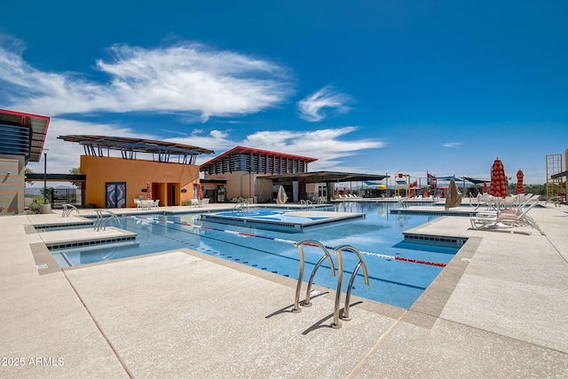 view of pool featuring a hot tub and a patio