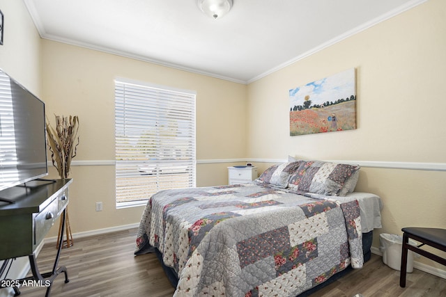 bedroom with wood finished floors, baseboards, and ornamental molding