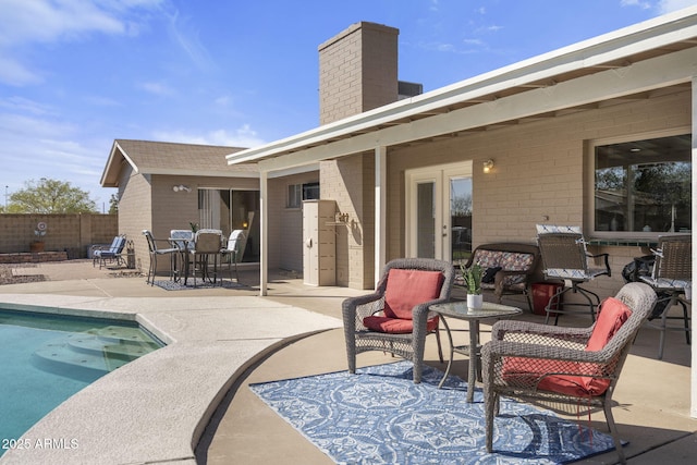 view of patio with fence and a fenced in pool