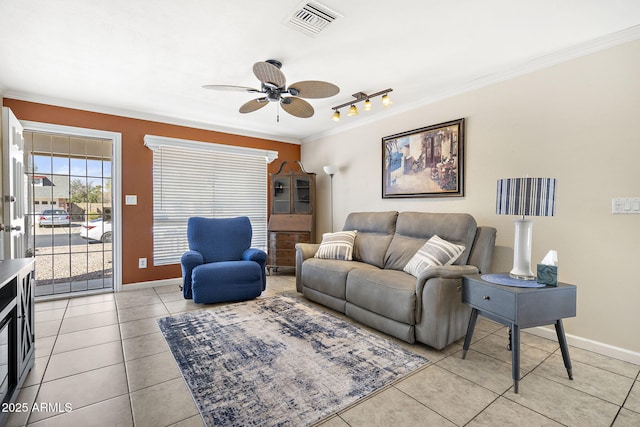 living area featuring visible vents, baseboards, ceiling fan, ornamental molding, and light tile patterned floors