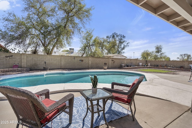 view of pool featuring a fenced backyard, a fenced in pool, and a patio