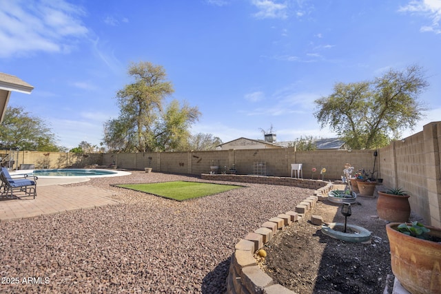 view of yard with a patio area, a fenced in pool, and a fenced backyard