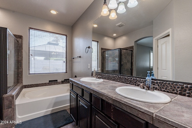 bathroom featuring separate shower and tub and vanity