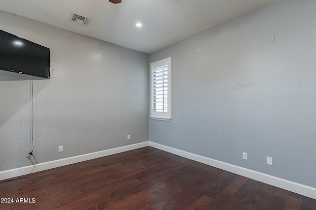 spare room with ceiling fan and dark hardwood / wood-style flooring