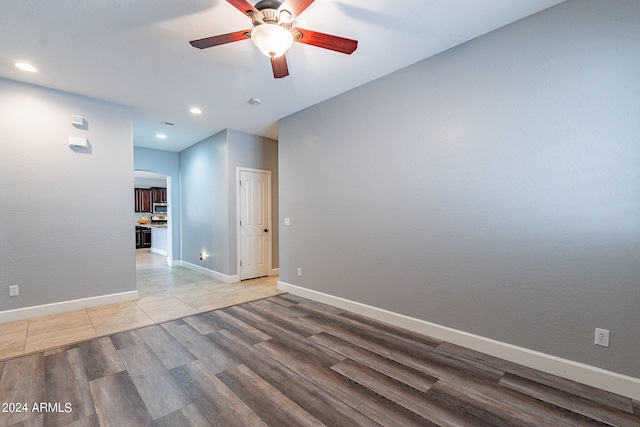 empty room featuring ceiling fan and hardwood / wood-style floors