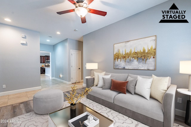 living room with light wood-type flooring and ceiling fan