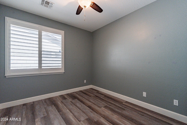 empty room with ceiling fan and dark wood-type flooring