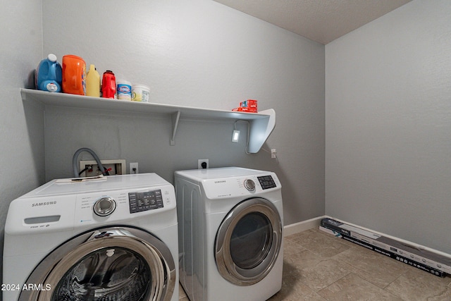 clothes washing area with a textured ceiling and washing machine and clothes dryer