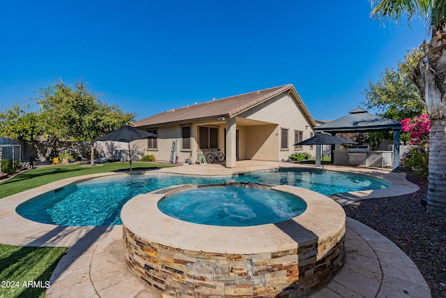 view of swimming pool with an in ground hot tub, a gazebo, and a patio area