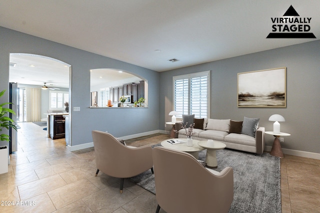 tiled living room featuring ceiling fan