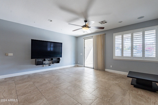 unfurnished living room with ceiling fan