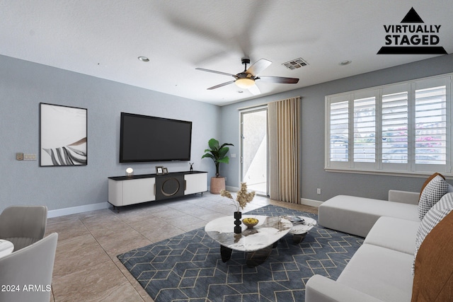 tiled living room with ceiling fan