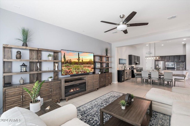 living room with ceiling fan and light tile patterned floors