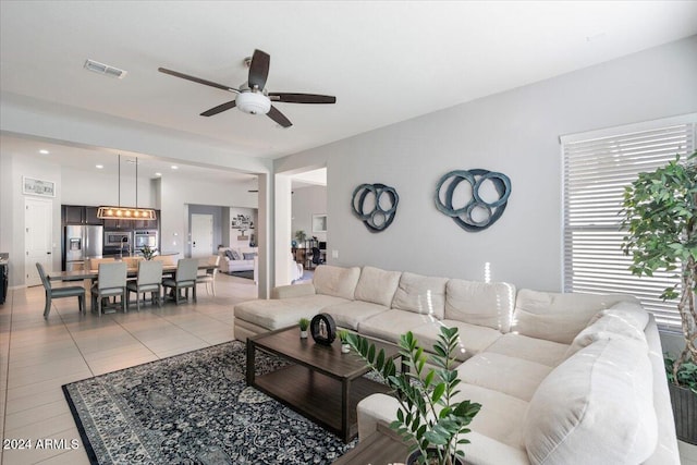 living room featuring light tile patterned floors and ceiling fan