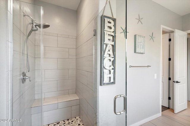 bathroom featuring hardwood / wood-style floors and walk in shower