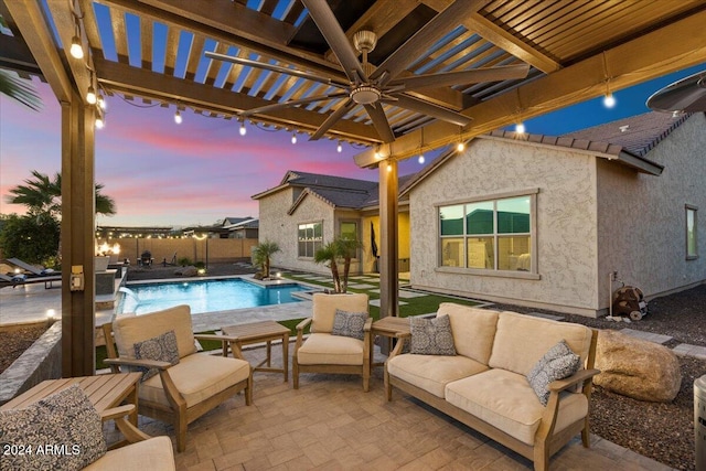 pool at dusk featuring an outdoor living space, a pergola, pool water feature, and a patio area