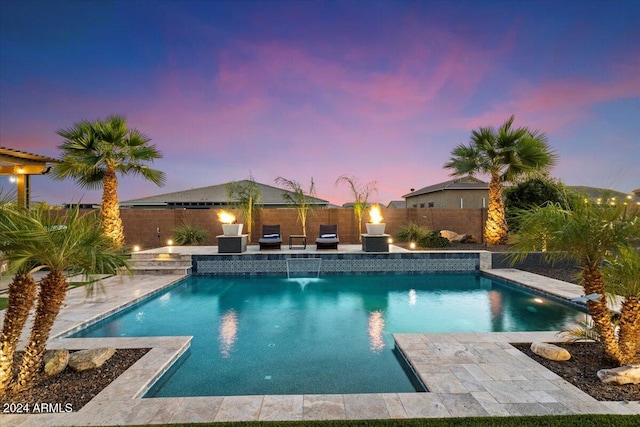 pool at dusk with pool water feature