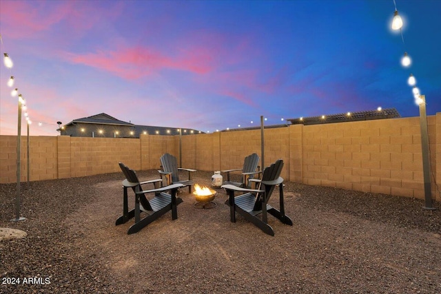 yard at dusk with an outdoor fire pit