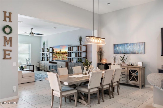 tiled dining room featuring ceiling fan