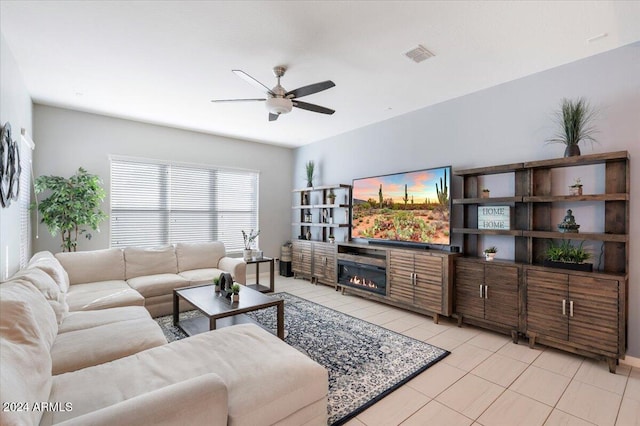 tiled living room with ceiling fan