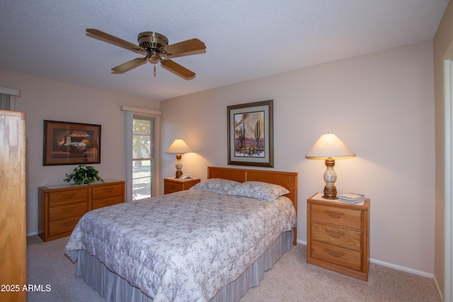 bedroom with light carpet, ceiling fan, and a textured ceiling